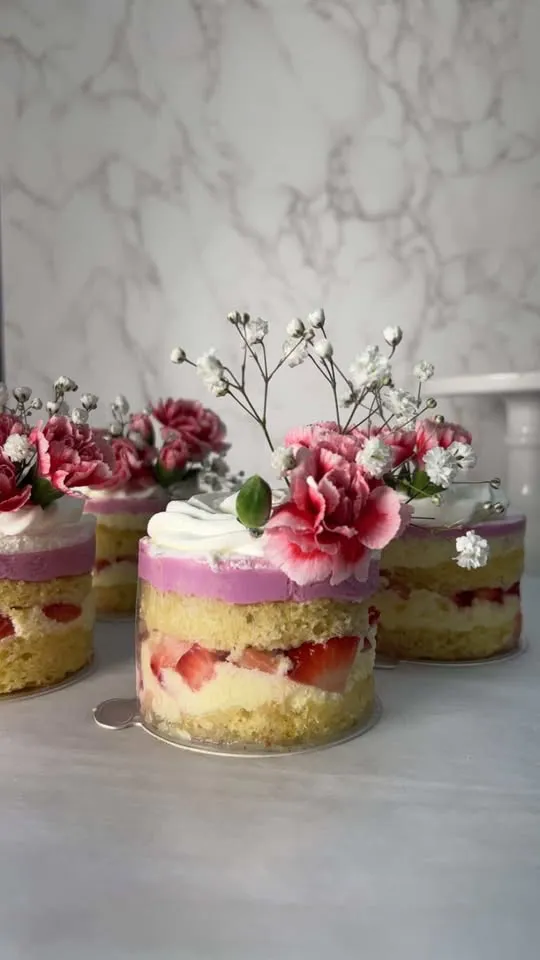 Mini strawberry layer cakes topped with pink carnations